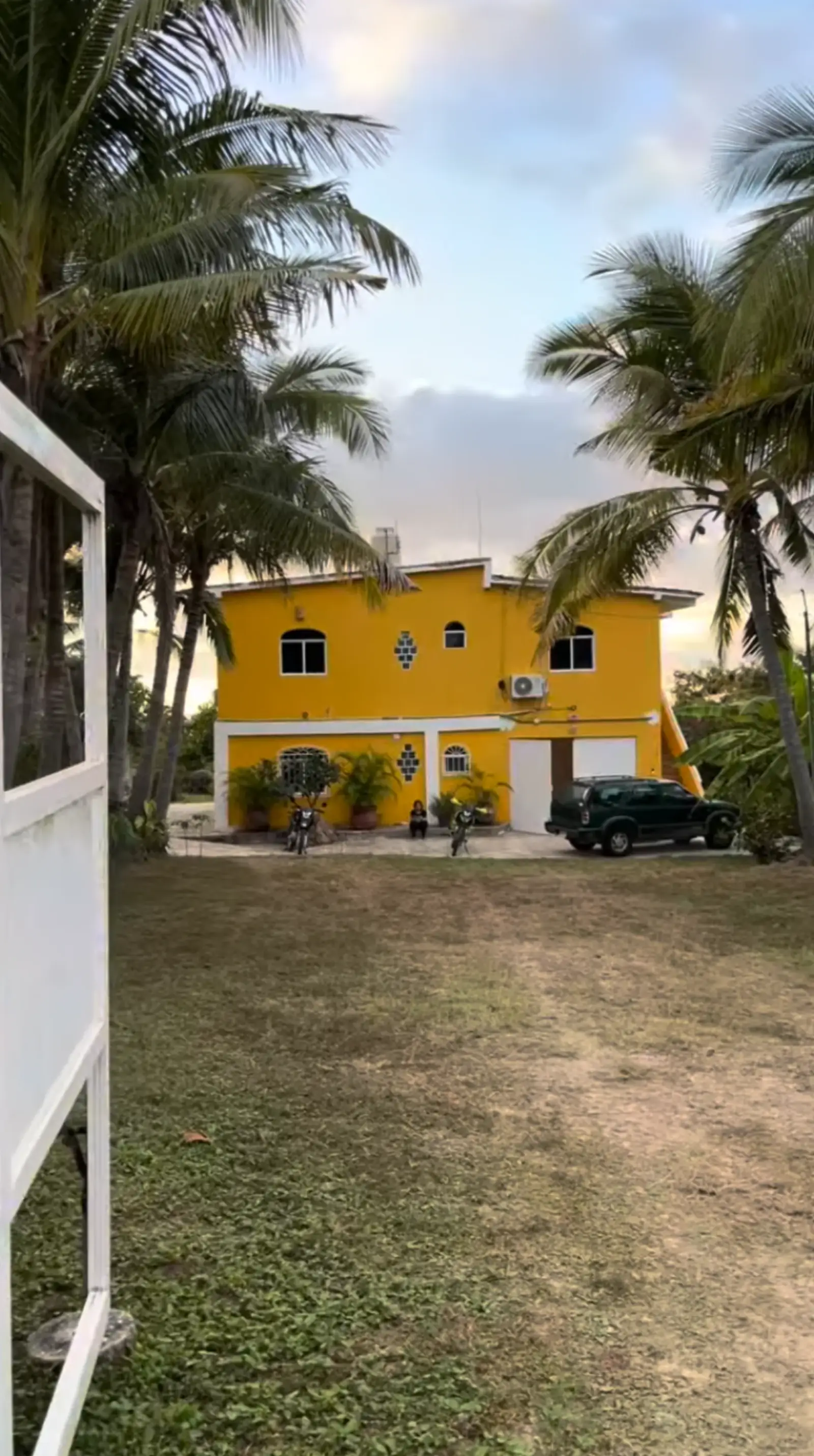Detail of Casa de Mango's yellow exterior in warm afternoon light