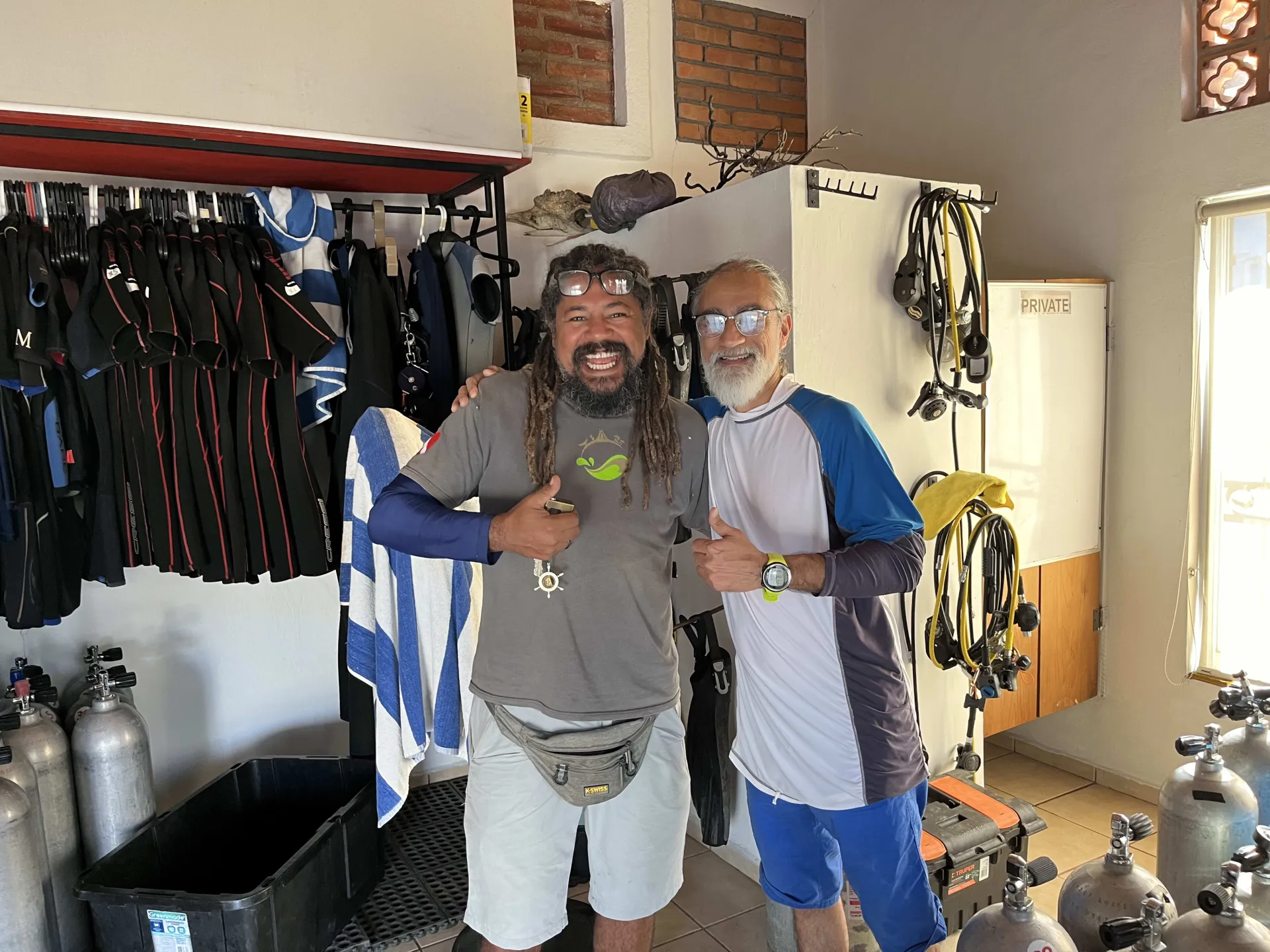 Scuba instructors giving a thumbs up before a dive