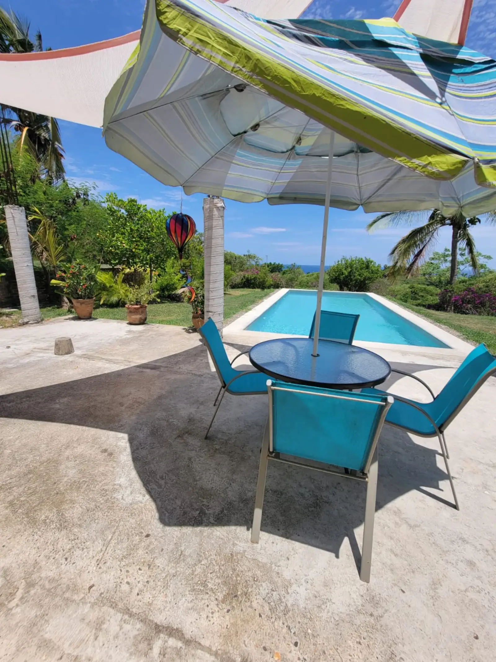 Poolside patio seating under umbrellas
